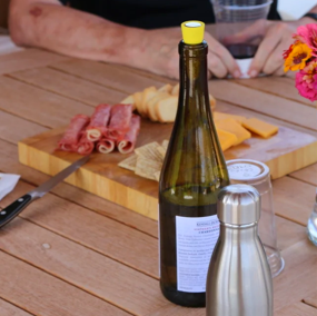 Bottle of Wine in Front of a Charcuterie Board