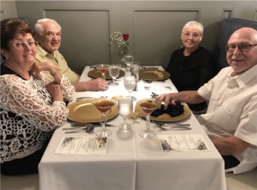 Senior Couples Smiling at Dinner Table