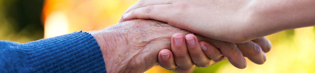 Senior residents clasping hands