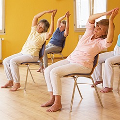 Seniors doing chair yoga