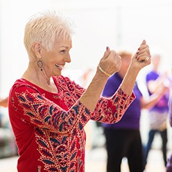 Senior woman smiling at dance fitness class